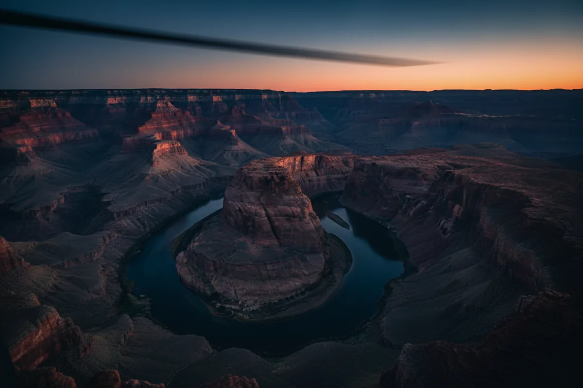 The Grand Canyon and Colorado River viewed from a helicopter at sunset.